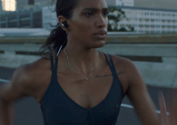 A focused woman running, symbolizing the endurance and resilience built through a daily commitment to foundational health and immunity training.